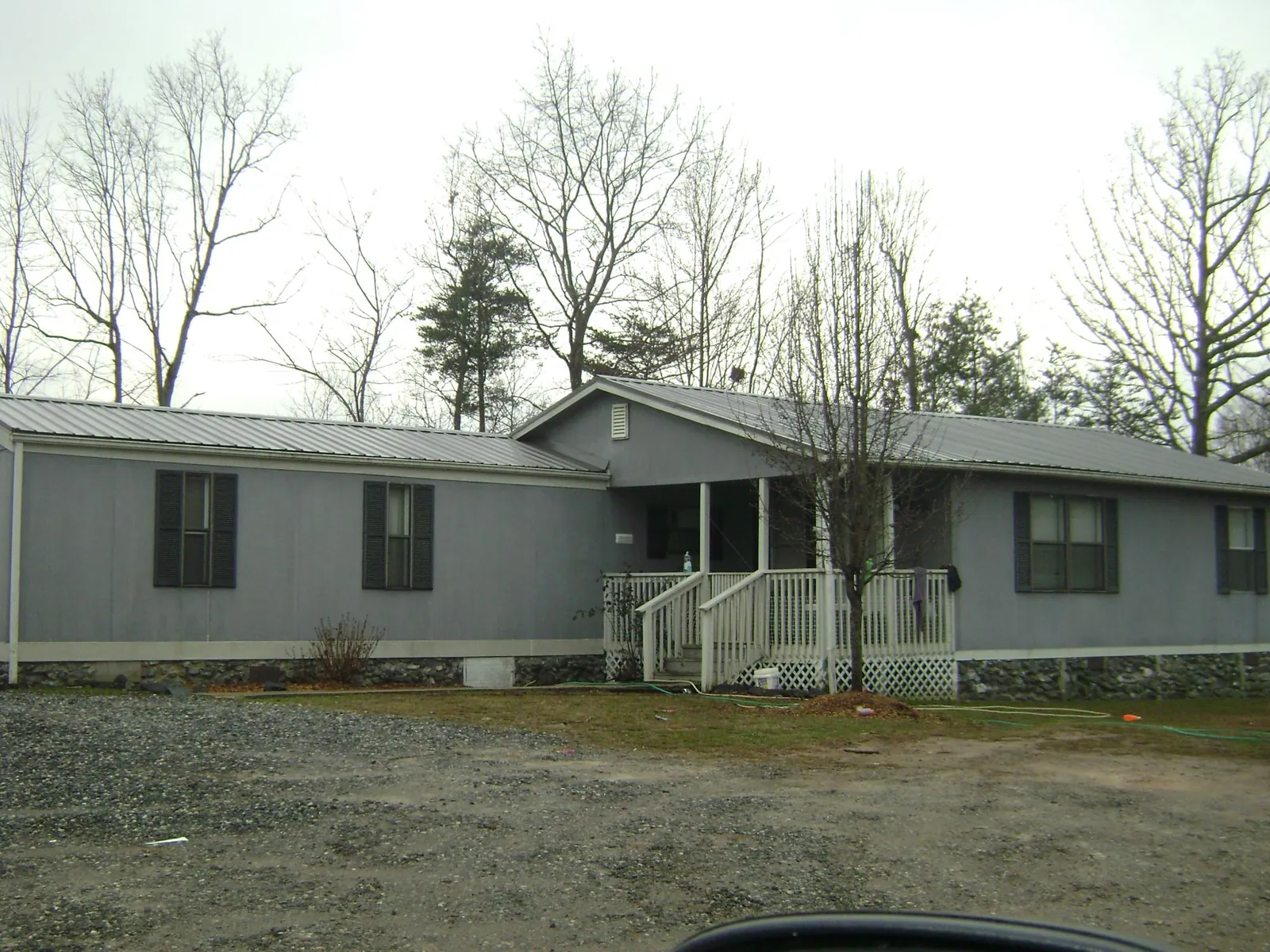 Metal roof over a manufactured home with a covered front porch in Newport